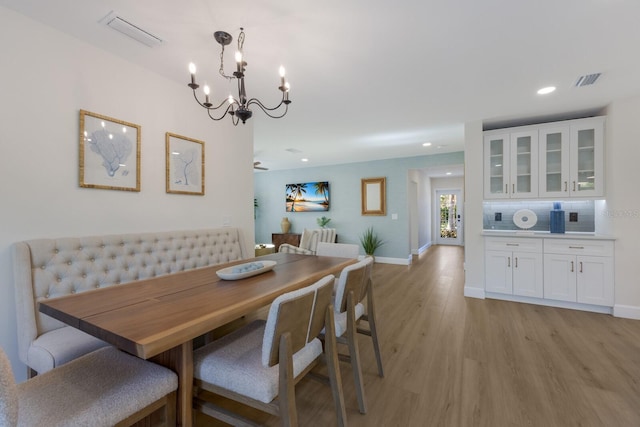 dining room featuring a chandelier and light hardwood / wood-style floors