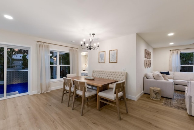 dining area featuring light hardwood / wood-style floors and a chandelier