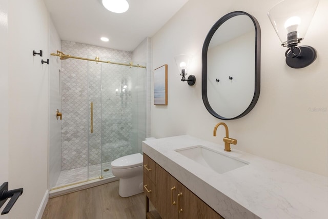 bathroom with vanity, hardwood / wood-style flooring, toilet, and walk in shower