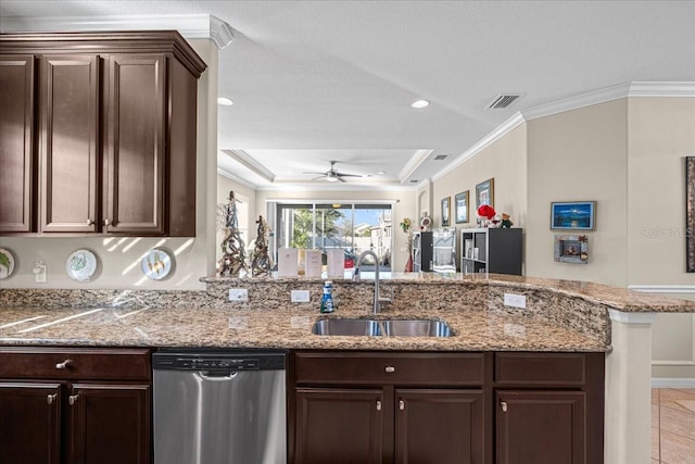 kitchen with kitchen peninsula, dark brown cabinets, a raised ceiling, sink, and dishwasher