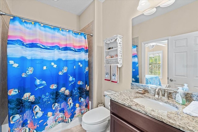 bathroom with vanity, a textured ceiling, and toilet