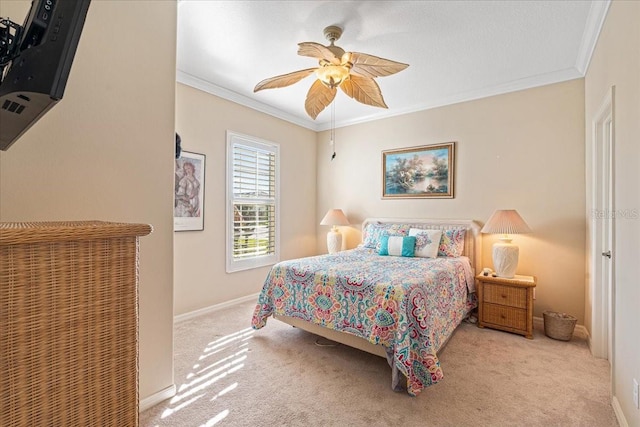 bedroom featuring ceiling fan, crown molding, and light colored carpet