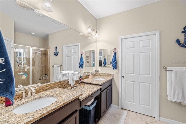 bathroom with vanity, tile patterned floors, and a shower with shower door