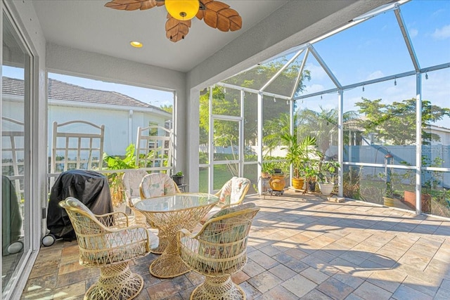 sunroom featuring ceiling fan