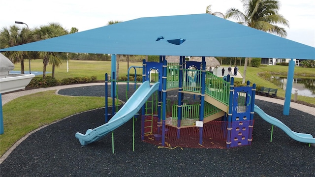 view of play area featuring a lawn and a water view