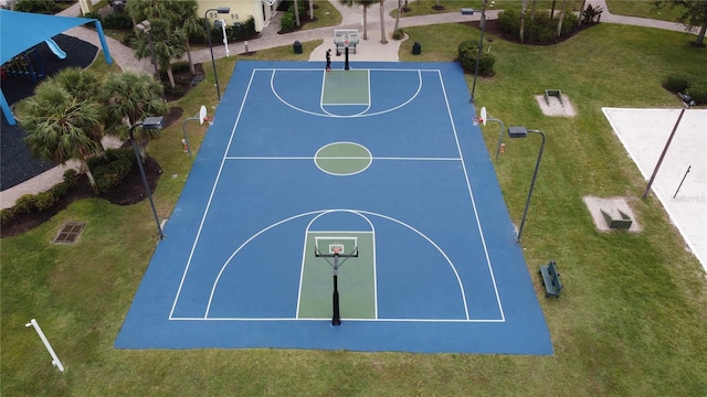 view of basketball court featuring a lawn