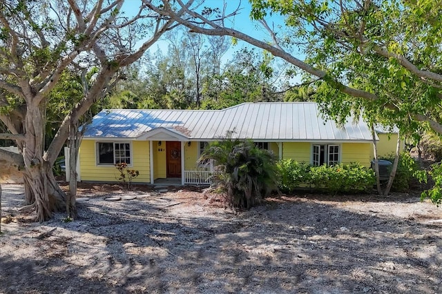 563 Juan Anasco Dr, Longboat Key, FL 34228 - ranch-style home with covered porch and metal roof