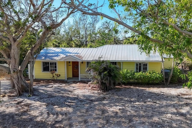 ranch-style home featuring metal roof