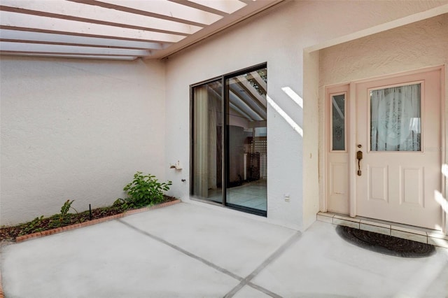 doorway to property with a patio