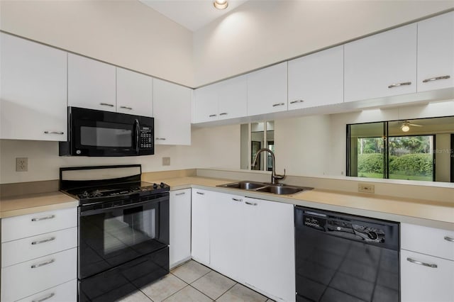 kitchen with sink, white cabinets, and black appliances