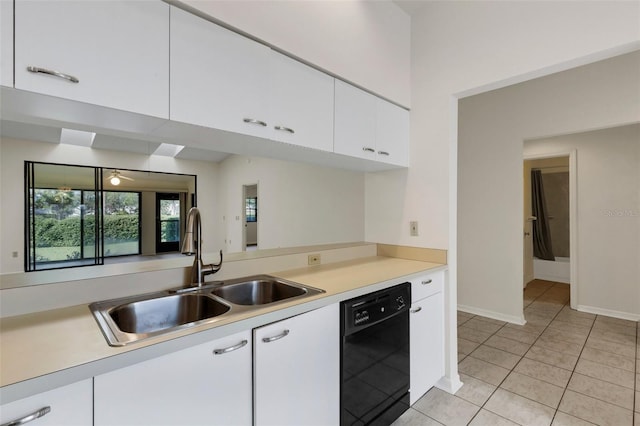 kitchen featuring sink, white cabinetry, black dishwasher, and light tile patterned floors