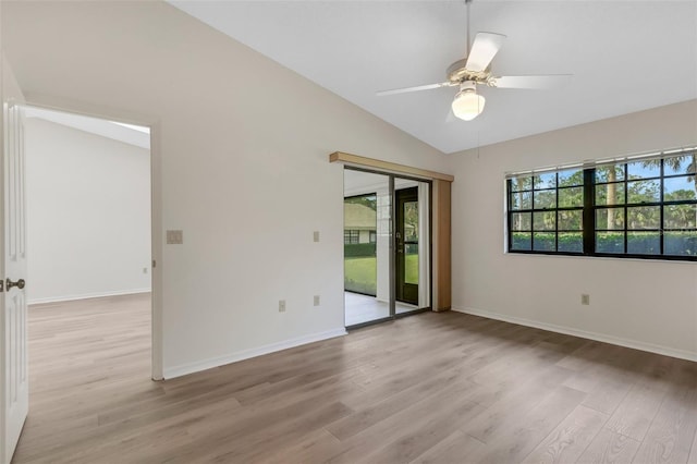 spare room featuring ceiling fan, light hardwood / wood-style floors, and vaulted ceiling