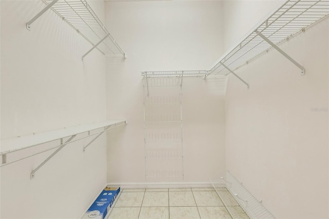 spacious closet with light tile patterned floors