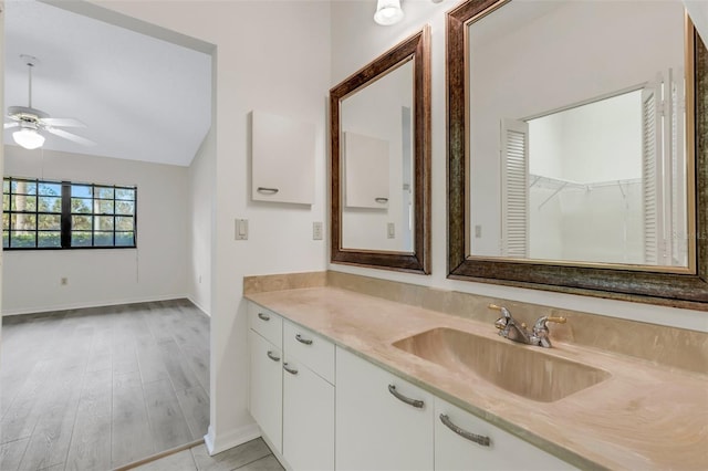 bathroom featuring ceiling fan, lofted ceiling, and vanity