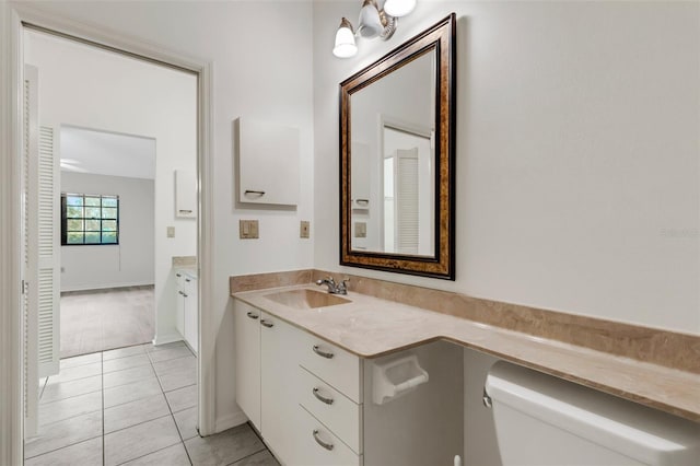 bathroom with tile patterned floors, vanity, and toilet