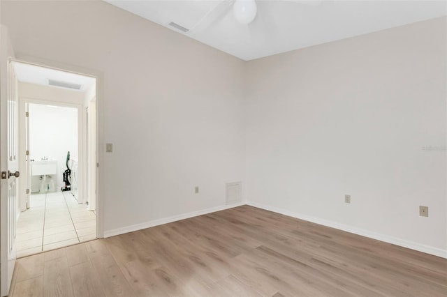 spare room featuring ceiling fan and light wood-type flooring