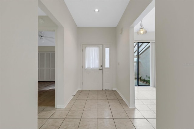 tiled foyer with ceiling fan