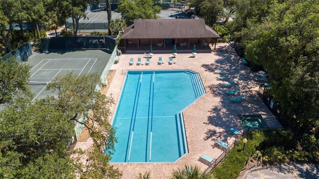 view of pool with tennis court