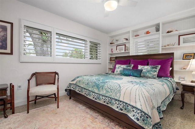 bedroom with a ceiling fan and baseboards