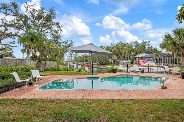 view of pool with a fenced in pool, a yard, and fence