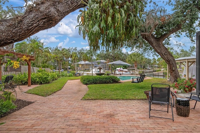 view of patio / terrace featuring an outdoor pool and fence