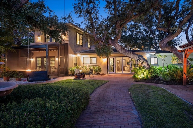 view of front of property featuring french doors, a patio, and a front yard