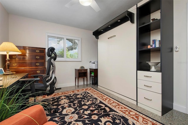 office featuring a ceiling fan and baseboards