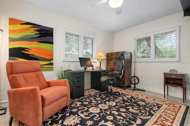 office area featuring a ceiling fan, baseboards, and speckled floor