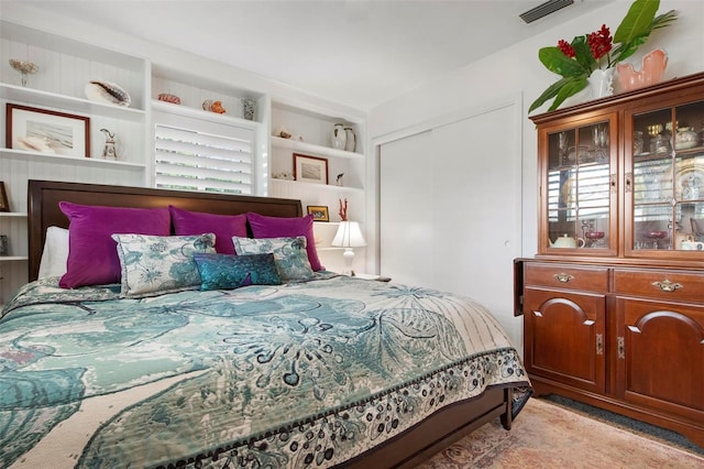 bedroom with a closet and visible vents