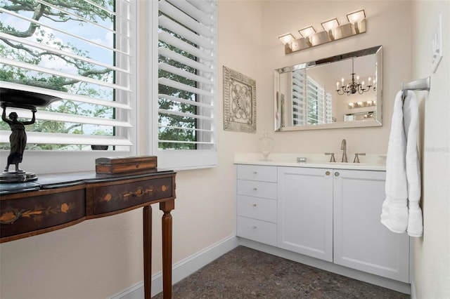 bathroom featuring speckled floor, vanity, and baseboards