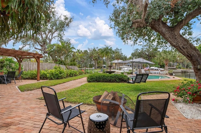 view of patio / terrace featuring an outdoor fire pit, a water view, fence, a fenced in pool, and a pergola