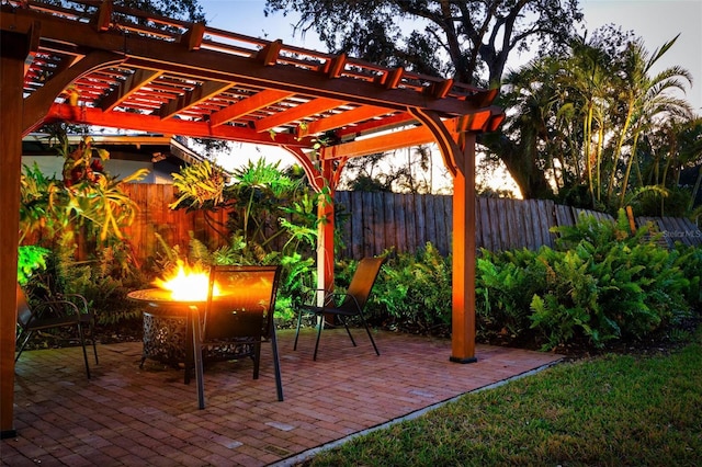 view of patio with an outdoor fire pit and a pergola