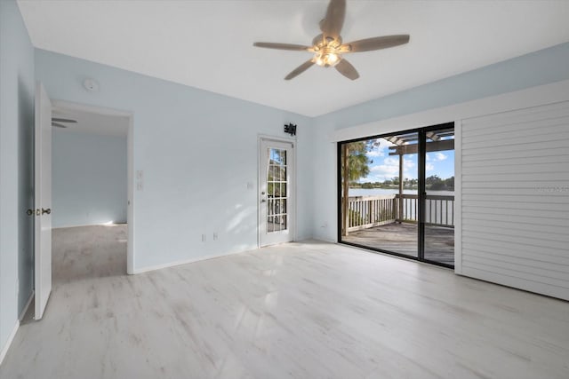 spare room featuring ceiling fan and light wood-type flooring