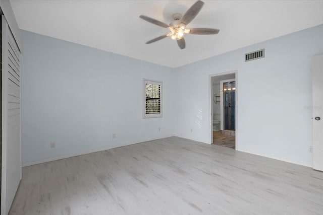 empty room with ceiling fan and light hardwood / wood-style floors