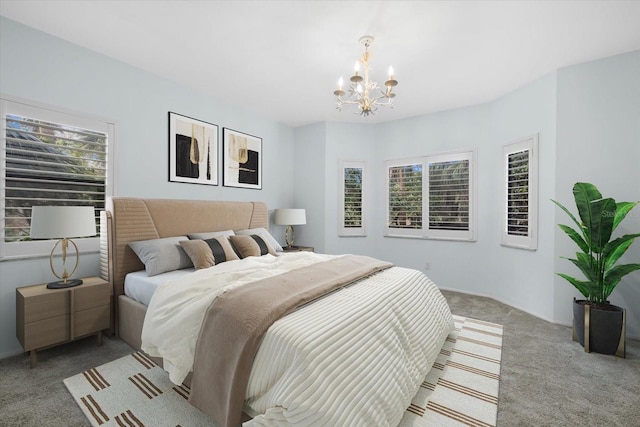 bedroom with light colored carpet and an inviting chandelier