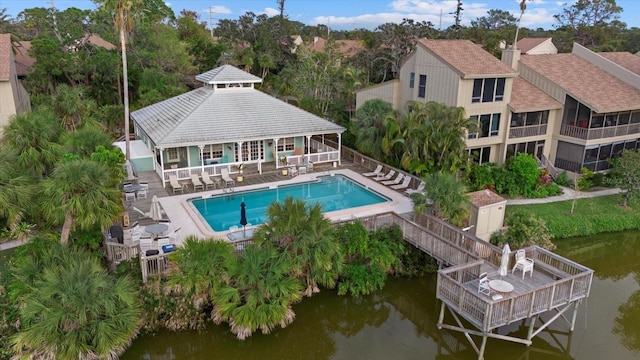 view of swimming pool featuring a water view and a patio