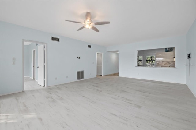 empty room with light wood-type flooring and ceiling fan