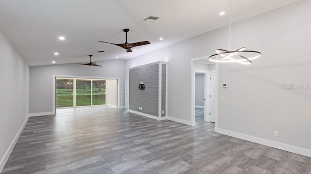 unfurnished living room with light wood-type flooring, ceiling fan with notable chandelier, and lofted ceiling