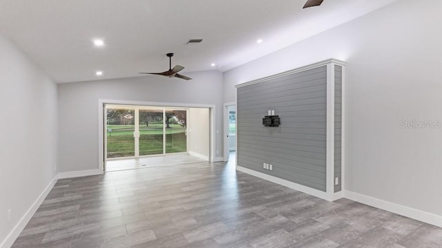 unfurnished room featuring light hardwood / wood-style flooring, ceiling fan, and lofted ceiling