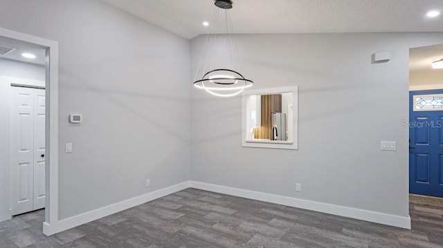 entrance foyer featuring hardwood / wood-style flooring and vaulted ceiling