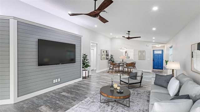 living room with wood-type flooring and ceiling fan