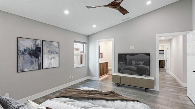 interior space with wood-type flooring, ensuite bathroom, vaulted ceiling, and ceiling fan