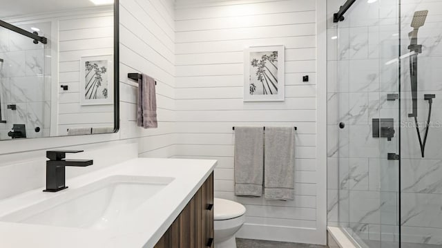 bathroom with wooden walls, vanity, an enclosed shower, and toilet