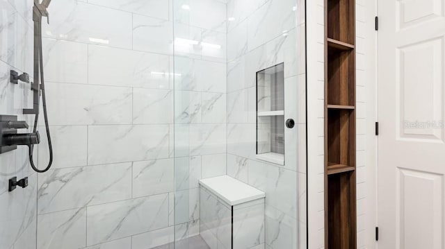 bathroom with a tile shower