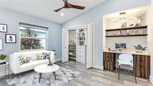 office area with ceiling fan, light hardwood / wood-style floors, and vaulted ceiling