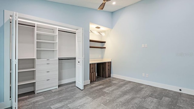 unfurnished bedroom with ceiling fan, wood-type flooring, and a closet