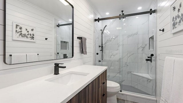 bathroom with a shower with door, vanity, and toilet