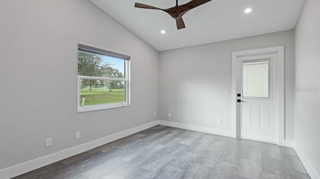 empty room featuring ceiling fan and lofted ceiling