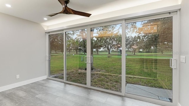 doorway featuring ceiling fan