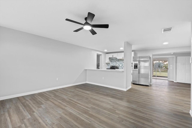 unfurnished living room featuring wood-type flooring and ceiling fan